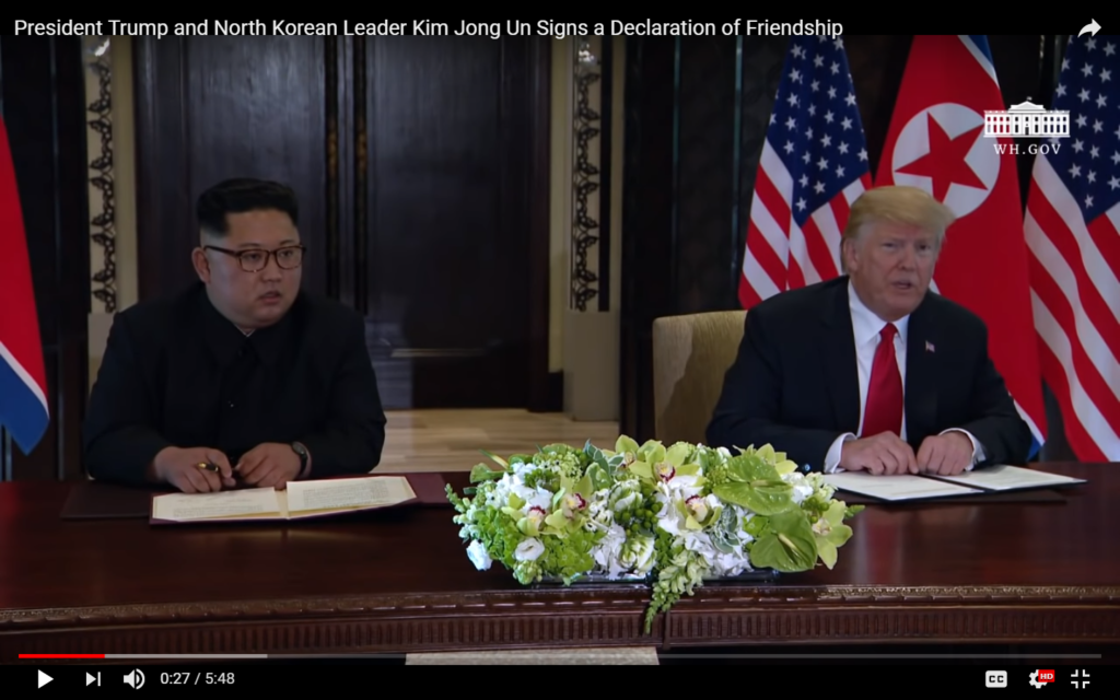 screenshot of President Trump and Chairman Kim at Singapore Summit, June 12, 2018