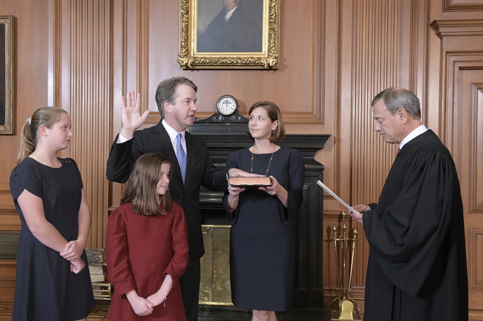 Chief Justice John G. Roberts, Jr., administers the Constitutional Oath to Judge Brett M. Kavanaugh in the Justices’ Conference Room, Supreme Court Building. Mrs. Ashley Kavanaugh holds the Bible. Credit: Fred Schilling, Collection of the Supreme Court of the United States.